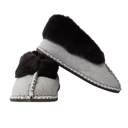 Pair of gray slippers with black fur lining on a white background